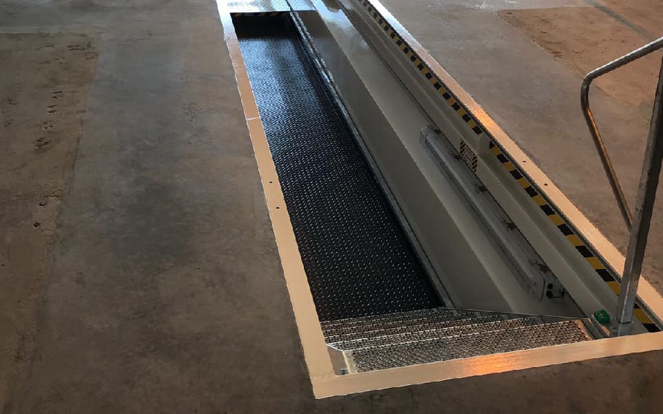 Garage equipment installation by CCS Garage Equipment of new galvanised steel vehicle inspection pit for Biffa’s depot at Roche, Cornwall, featuring anti-slip integrated steel stairs