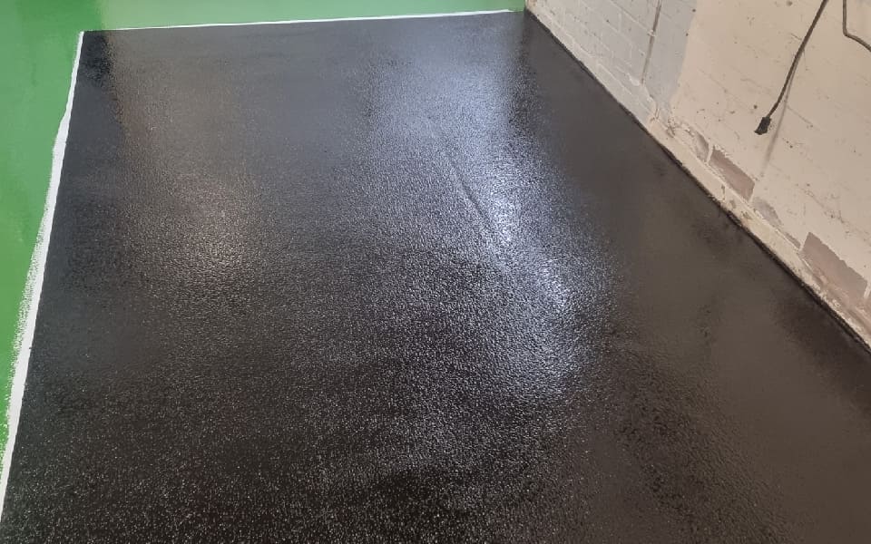 Hard-wearing epoxy resin vehicle workshop flooring installed by CCS Garage Equipment at East Midlands Airport