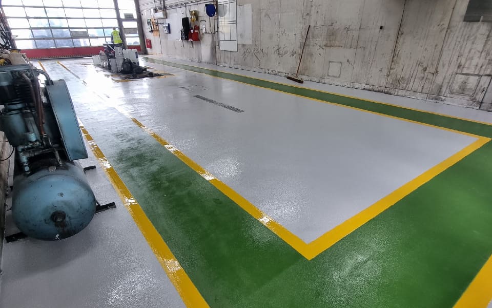 Clean and smooth surface in airport vehicle maintenance workshop, with new floor layout designed and installed by CCS Garage Equipment at East Midlands Airport