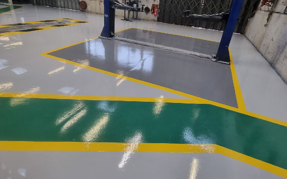 Brightly-coloured, highly visible guided walkway area in a layout designed and installed by CCS Garage Equipment for East Midlands Airport