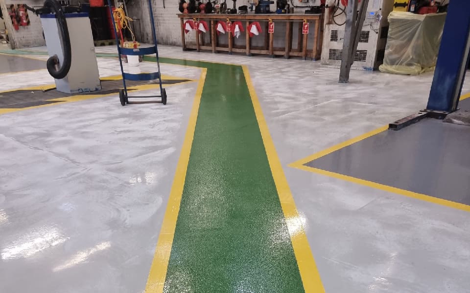 Guided walkway creating safe working and transitional zones for the East Midlands Airport vehicle workshop team, designed and installed by CCS Garage Equipment