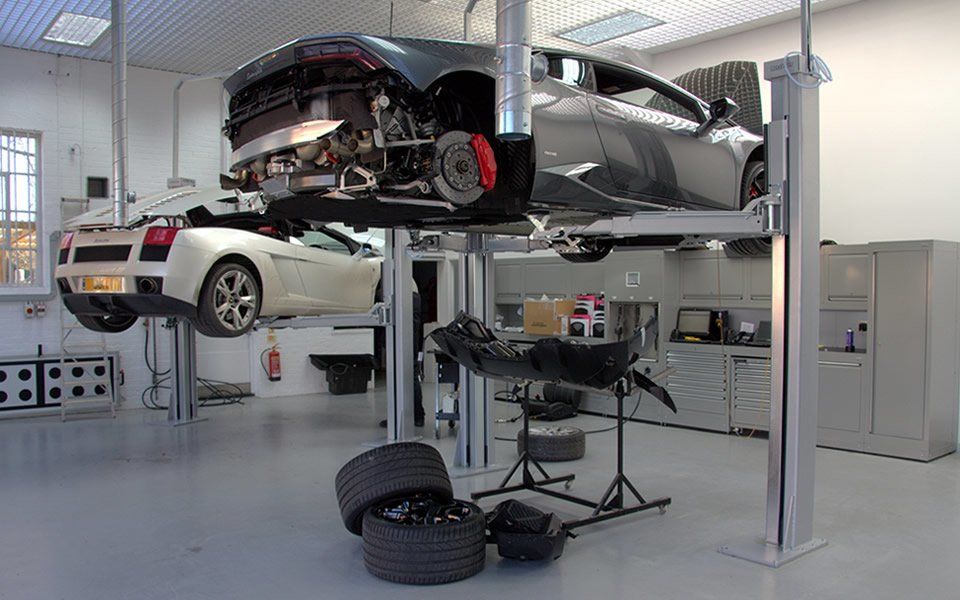 Vehicle undergoing maintenance on 2-post Nussbaum lift at Lamborghini, Pangbourne’s servicing workshop installed by CCS Garage Equipment