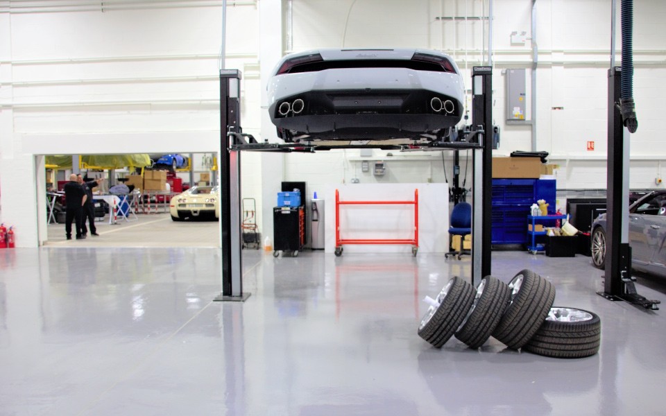 Vehicle lifted on industry-leading 2-post Nussbaum Smart Lifts in spacious servicing workshop designed and installed by CCS Garage Equipment