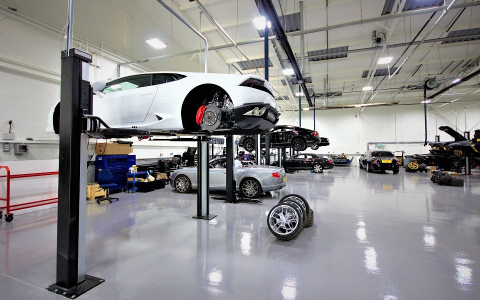 Garage equipment design and installation by CCS Garage Equipment for Lamborghini brand dealership featuring leading 2-post Smart Lifts by Nussbaum