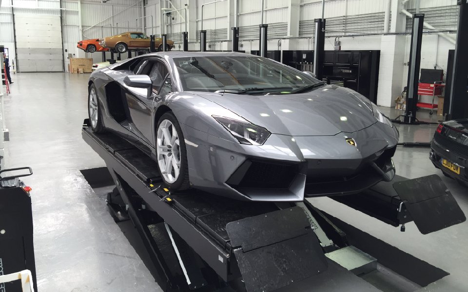 Vehicle lifted on recessed scissor lift for flat vehicle entry and exit, installed in new servicing facility by CCS Garage Equipment for Lamborghini, Stockport