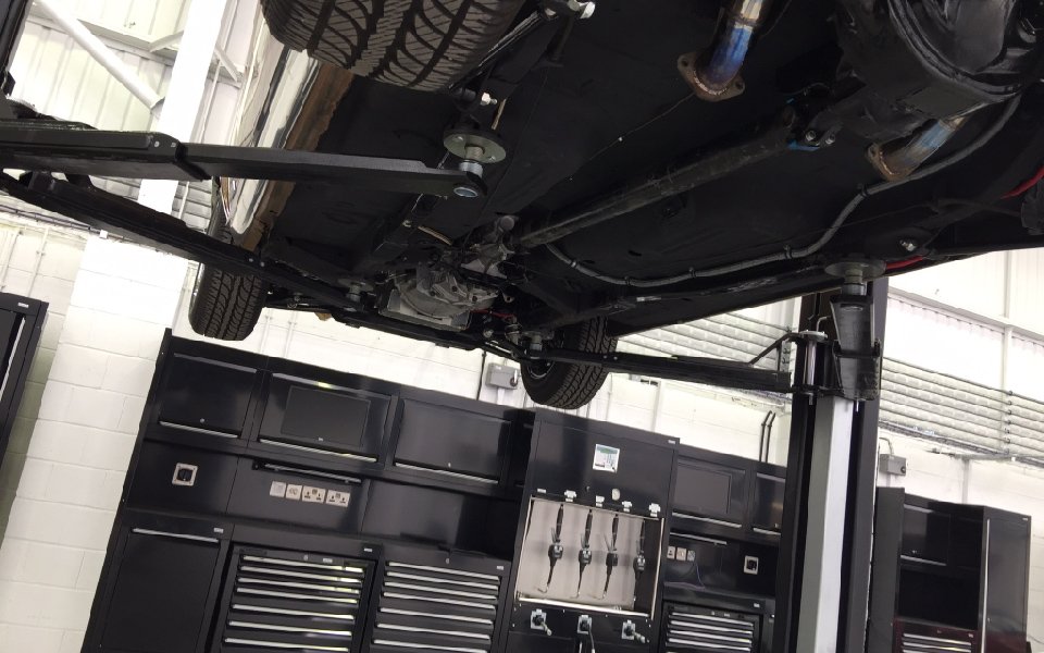 Vehicle maintenance on a Nussbaum fixed 2-post lift, part of CCS Garage Equipment’s garage equipment installation project at Lamborghini, Stockport